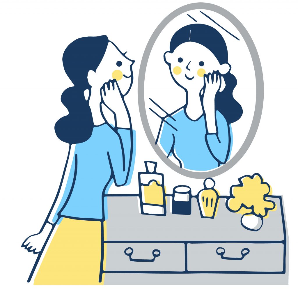 鏡で自分の顔を見る女性
